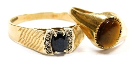 A 9ct gold sapphire and diamond ring, in a high setting with engraved shoulders, size V, together with a 9ct gold and tiger's eye signet ring, size K, 4.7g. (2)