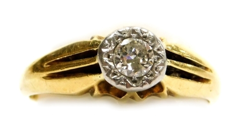 An 18ct gold and diamond solitaire ring, in a claw setting with channelled shoulders, approximately ¼ct, size Q, 4.9g.