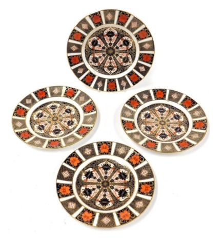 Four Royal Crown Derby Old Imari pattern porcelain plates, three 21.5cm diameter, and the other 23cm diameter.