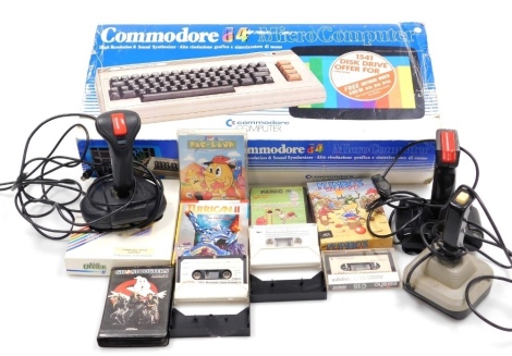 A Commodore 64 computer, boxed, together with various games, Pac Land, Panic, joysticks, etc. (a quantity)