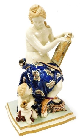 A Kerr and Binns Worcester majolica figure group, circa 1870, modelled as Venus seated with a picture, her right foot resting on a stool, with a putto holding a jug kneeling at her side, raised on a shaped base, printed mark, 38cm high. (AF)