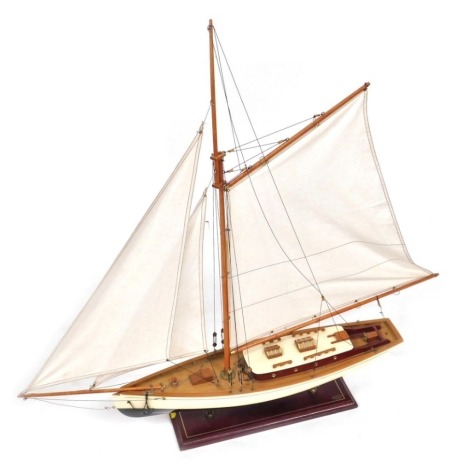 A Nauticalia London model yacht, on a rectangular hardwood base, 85cm high overall, 86cm wide.