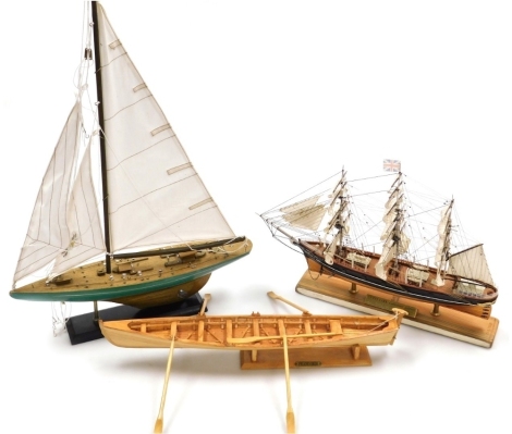 Three model boats, comprising The Cutty Sark, collectors edition, numbered 509-1869, bearing name plaque stating 'this hand crafted model is mounted on a section of decking salvaged from The Cutty Sark during restoration,' 33cm high, 40cm wide, together w