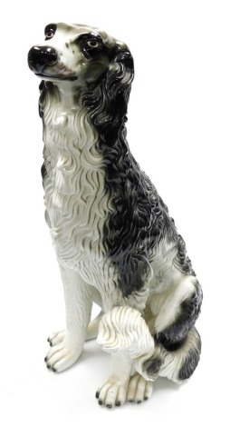 A large pottery figure of a Saluki, black and white colouring, 75cm high.