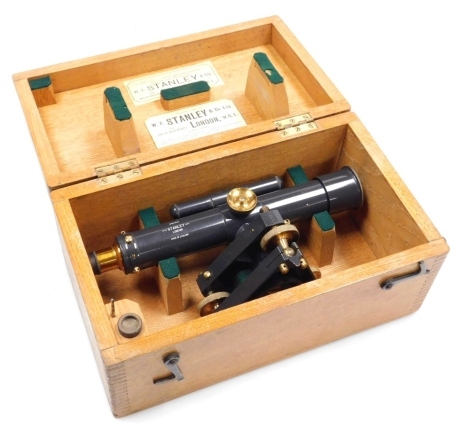 A mid century Stanley of London tacheometrical telescope, precision level, number 36056, in an oak case, the lid bearing paper labels, the case 30cm wide.