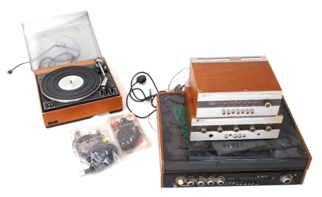 A mid century teak cased music system, comprising a Leak Delta 30 amplifier, a Leak Delta AM/FM tuner, a Goodmans Module 80 turntable, and a Garrard turntable, with various cables, etc. Buyer Note: WARNING! This lot contains untested or unsafe electrical 