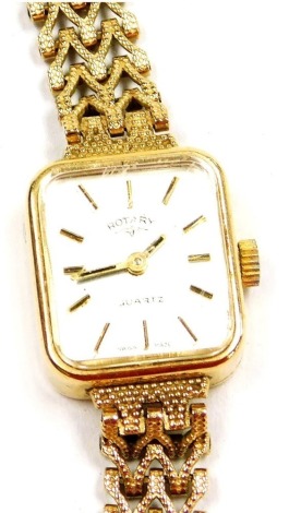 A Rotary 9ct gold lady's wristwatch, rectangular silvered dial, gold batons, quartz movement, on a gold strap, 13.0g all in.