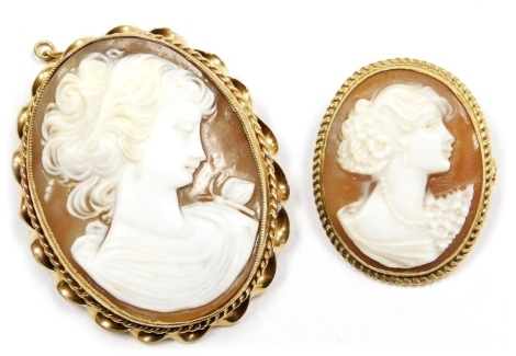 A 9ct gold and shell cameo brooch, bust portrait of a lady with a butterfly, with safety chain as fitted, 40mm x 33mm, and a further 9ct gold and cameo brooch, bust portrait of a lady with floral corsage and wearing a string of pearls, 26mm high x 20cm wi