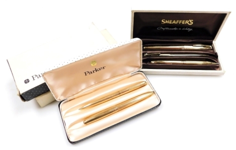 A Sheaffer's gold plated three piece pen and pencil set, comprising a cartridge pen with 14ct gold nib, ballpoint pen and a pencil, cased, together with a Parker Duette gold plated ballpoint pen and pencil, cased and outer boxed. (2)