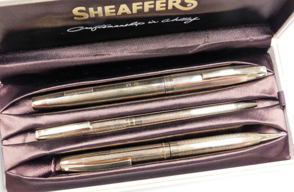A Sheaffer's gold plated three piece pen and pencil set, comprising a ...