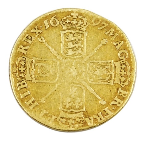 A William III gold guinea 1698, reverse with crowned cruciform shields, sceptres in angles, 8.1g.