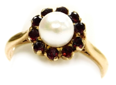 A cultured pearl and garnet ring, in a yellow metal basket mount, stamped 9ct, size N, 3.3g.