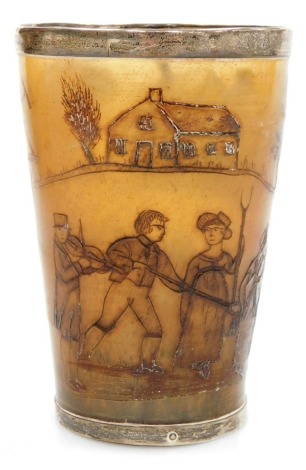 An early 19thC horn beaker, engraved with agricultural figures, implements and houses, with white metal mounts, 10cm high.