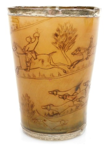 An early 19thC horn beaker, engraved with hunting figures on horseback and hounds, a fox and houses, with white metal mounts, 12cm high.