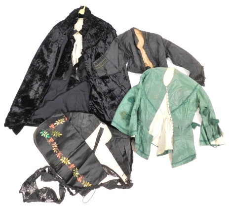 A group of Victorian and later clothing, to include a black velvet cape, green satin and embroidered lady's over jacket, a black satin and fringed jacket, etc.