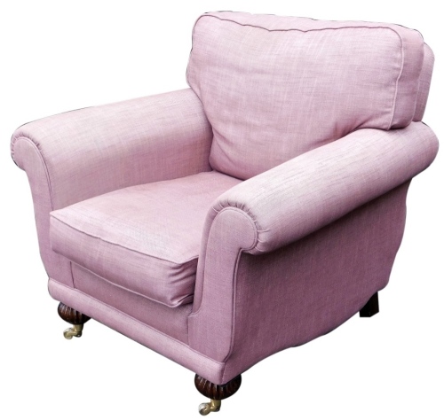 A Laura Ashley armchair, upholstered in mauve fabric, with scroll arms, raised on fluted legs, brass capped on castors, 98cm wide.