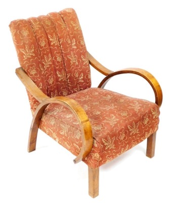 An Art Deco bentwood armchair, with a red and cream foliate overstuffed seat and fluted back, raised on square legs.