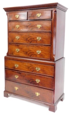 A George III mahogany chest on chest, the out swept pediment over two short above six long drawers, raised on bracket feet, 175.5cm high, 110cm wide, 51cm deep.