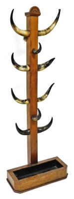 An oak and cow horn coat stand, raised on a canted rectangular base with drip tray insert, 173cm high.