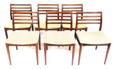 A set of six 1970s Danish rosewood dining chairs by Sorg Stolefabrik, with low raked ladder backs and over upholstered seats in plain woven fabric, raised on slender tapered legs. The upholstery in this lot does not comply with the 1988 (Fire & Fire Furn