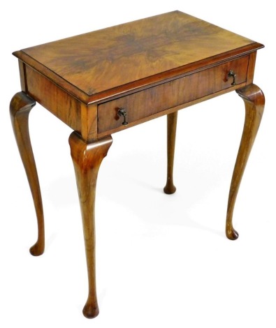 An early 20thC walnut side table, with a single frieze drawer, raised on slender cabriole legs, 73cm high, 64.5cm wide, 40cm deep.