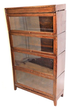 A Globe Wernicke style oak bookcase, with four glazed up and over doors, raised on square legs, 146cm high, 87cm wide, 31cm deep, (AF).