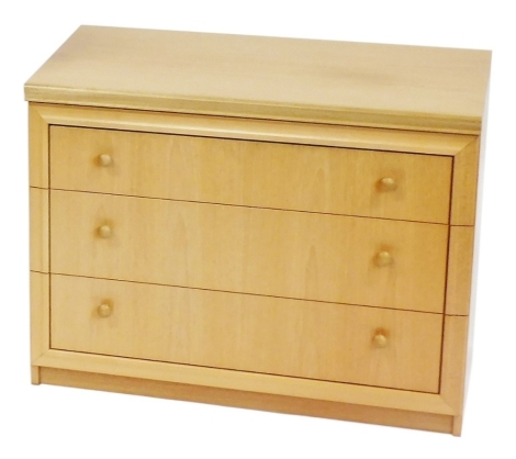 A William Lawrence light teak chest of three drawers, currently for CD usage, 64cm high, 82.5cm wide, 44.5cm deep.