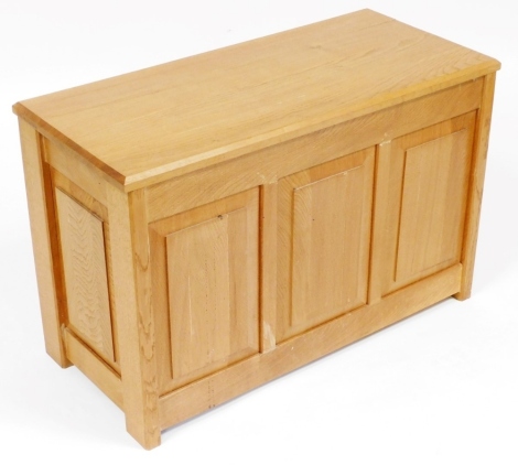 A light oak blanket chest, with a triple panelled front, 52cm high, 80cm wide, 36.5cm deep.