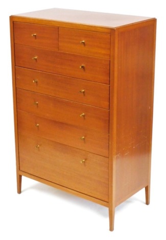 A 1950s mahogany chest, of two short over five long drawers, one with a fitted interior, raised on tapering square legs, 131cm high, 84cm wide, 45.5cm deep.