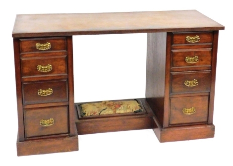 A Victorian mahogany twin pedestal desk, the central recess with a foot rest, flanked by eight short drawers, raised on a plinth base, 78cm high, 132cm wide, 52.5cm deep.