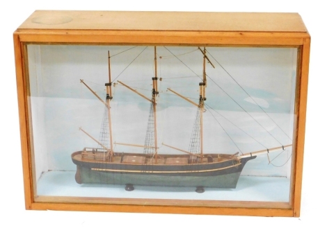 A wooden scale model of a barque sailing vessel, contained in a Perspex fronted oak display case, case 63cm high, 91cm wide, 28cm deep.