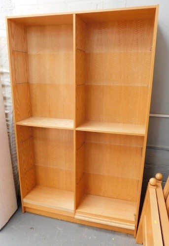 An oak veneer bookcase, with an arrangement of shelves, 193cm high, 120cm wide, 33cm deep. Lots 1501 to 1553 are available to view and collect at our additional premises SALEROOM NINE, Unit 9 Chandlers Yard, Grantham, NG31 6PG. For more details please cal