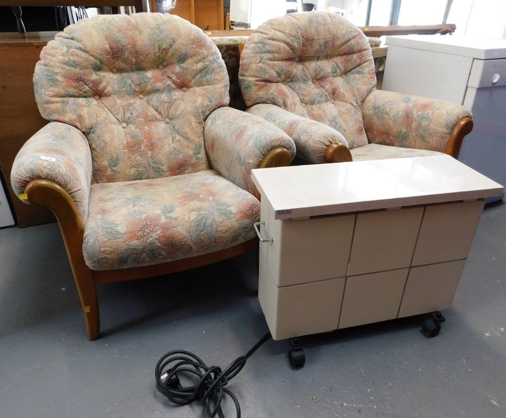 A pair of oak framed cottage style armchairs upholstered in