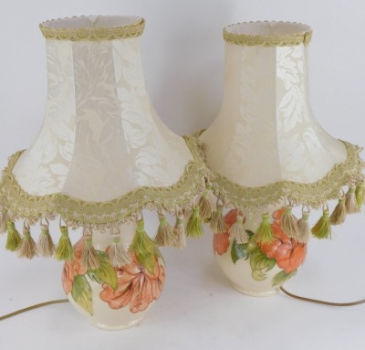 A pair of Moorcroft Hibiscus pattern table lamps, each on a cream ground, stamped to underside, with shades, 48cm high. (2) - 2