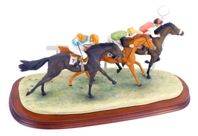 A Border Fine Arts horse racing trio group, depicting three horses and riders, signed Geenty, stamped BFA Scotland 1988, limited edition 113/250, on wooden plinth base, 24cm high, 43cm wide.