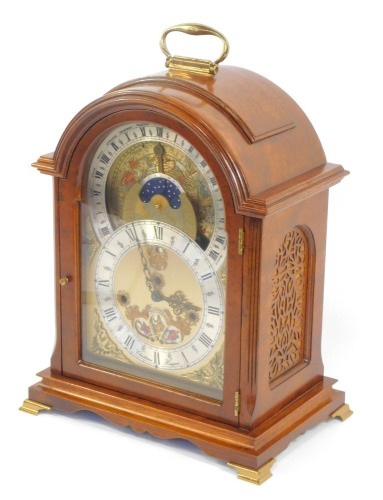 A Christiaan Huygens burr walnut table clock, the oval brass dial with silvered chapter ring bearing Roman numerals, date day apertures, the upper phase with month and astrological dial, fronted by a constellation dial, chapter ring showing the comparable