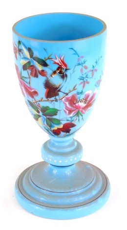 A Victorian blue glass vase, with a gilt rim, painted with a design of birds and flowers, on a stepped circular base, 27cm high. (AF)