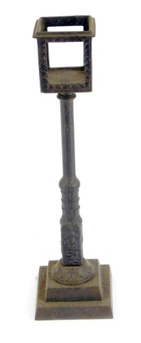 A late 19thC German cast iron watch holder, by E G Zimermann, of lampost form, with a square set top on reeded floral column, above a stepped foot, impressed marks, 25cm high.