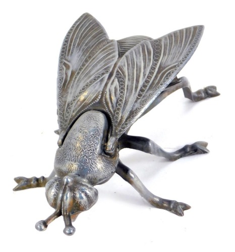 A novelty metal fly box, with a hinged winged body, 19cm diameter.