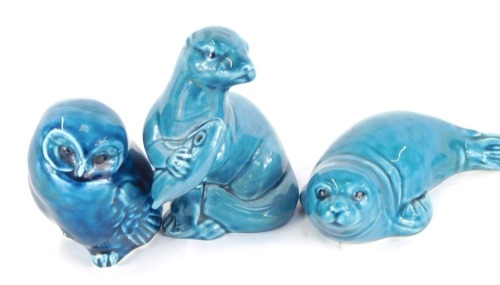 Three Poole pottery animal figures, comprising owl, 8cm high, otter with fish, 12cm high, and a seal, 15cm wide. (3)