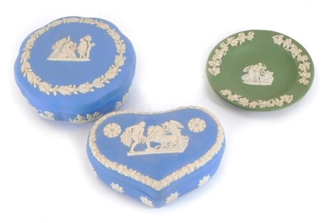 Three items of Wedgwood jasperware, comprising a blue jasperware heart shaped trinket box, blue jasperware circular trinket box and a green jasperware pin dish. (3)