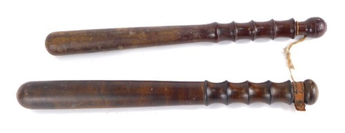 Two turned wooden police truncheons, 39cm wide.