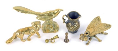 A group of brass wares, comprising a seated bird, fox, fly trinket box, miniature thistle shaped jug, miniature bugle and candlestick. (6)