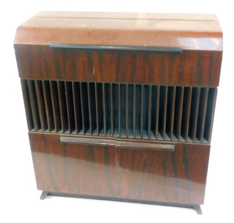 A Decola cased radiogram, with a Garrard record player, model RC88-4, in a walnut finish case, 104cm high, 96cm wide, 40cm deep. WARNING! This lot contains untested or unsafe electrical items. It is supplied for scrap or re-conditioning only. TRADE ONLY