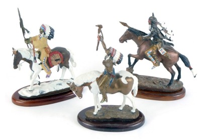 Three Hamilton Collection warrior figures, comprising Windrider by Chuck Wren, Spirit of the Plains by Chuck Wren, and a further example unmarked, each on an oval base, 18cm high, 12cm wide. (3)