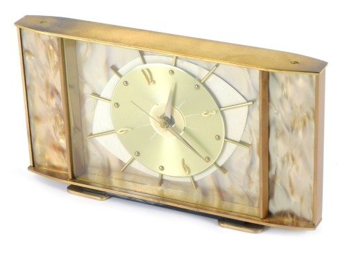 A Metamec 1950s/60s mantel clock, with a central eye design dial, with baton dial, with a mother of pearl style finish in brass outer casing, 15cm high, 28cm wide.