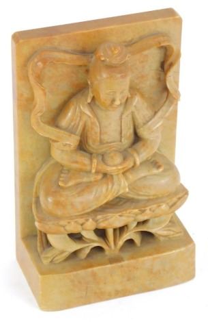 A Chinese carved soapstone figure, of a seated Buddha on a lotus leaf, holding a pot, 18cm high, 10cm wide, 5.5cm deep.