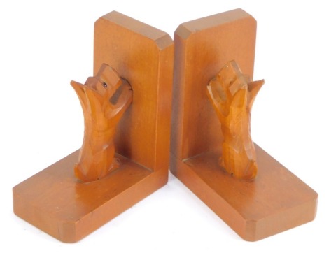 A pair of 1930s wooden bookends, each carved with a terrier, 15cm high, 12cm wide. (2)