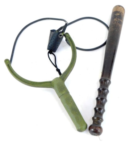 An ebonised policeman's truncheon, 38cm high, and an army sling slot, 26cm high. (2)