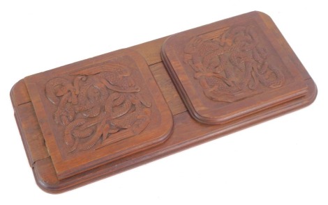 An early 20thC carved Celtic carved oak book slide, with serpent engraved panels, and moulded ends, 37cm wide, 17cm deep.